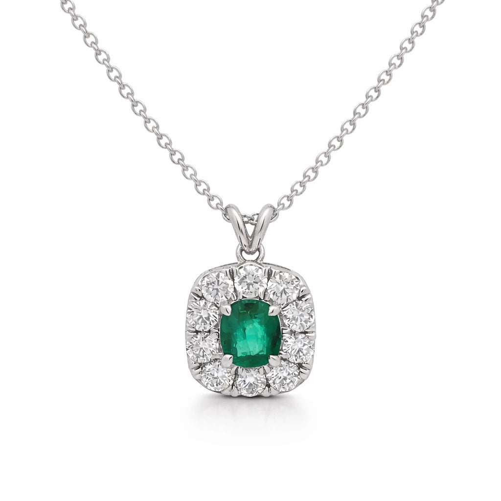 Emerald and diamond pendant on a white background